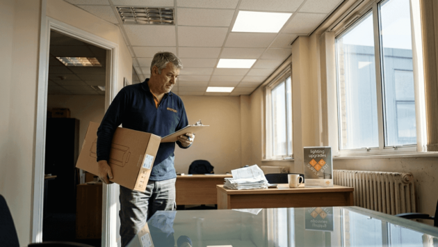 Manager surveying LED upgrade in corner office