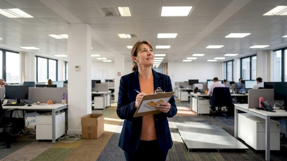 Manager surveying office lighting installation